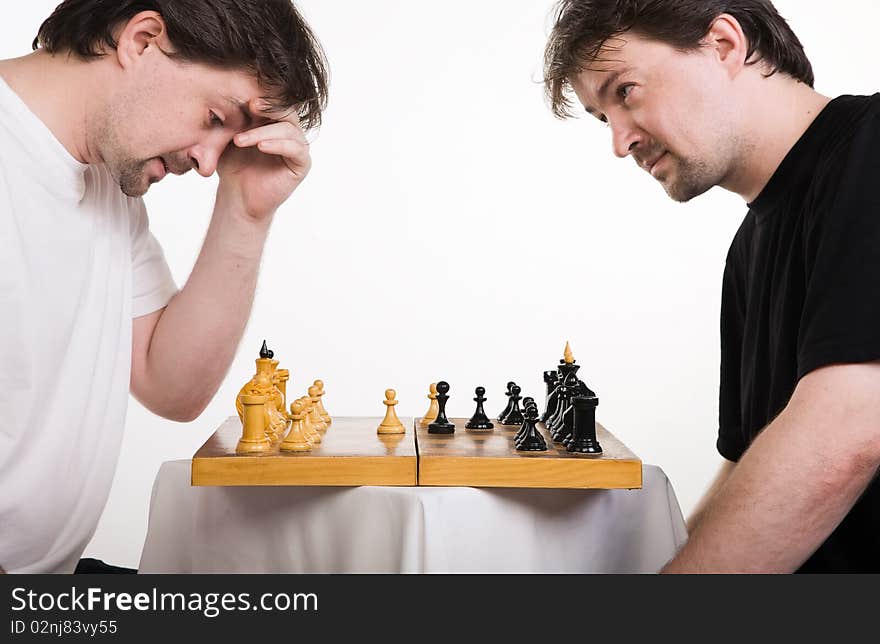 Two men play a chess