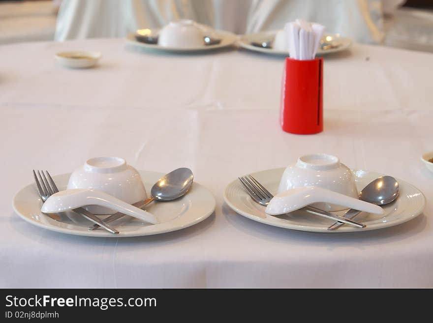 Thai resturant Place setting, A dish, bowl, spoon and fork on a table