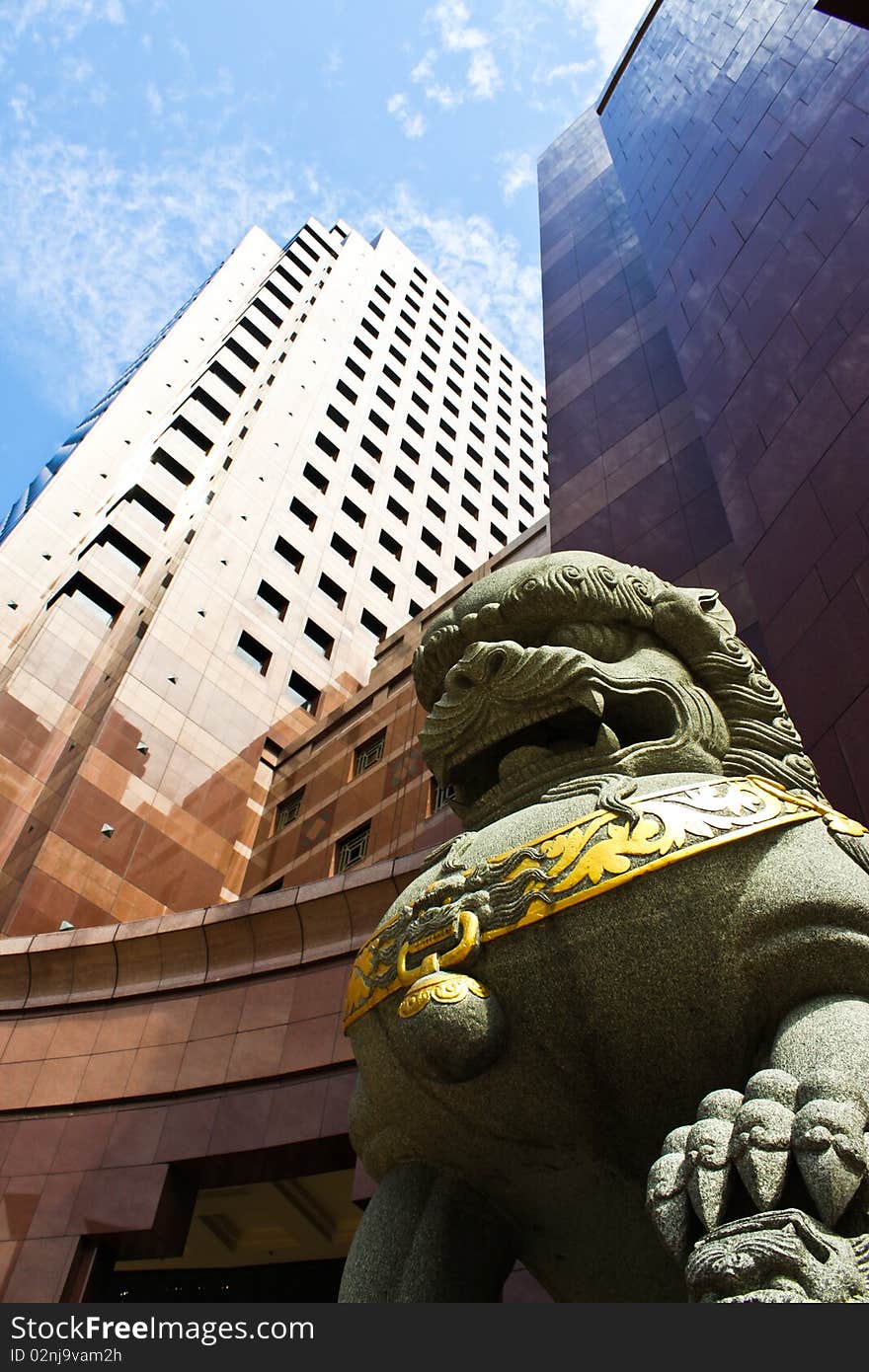 A lucky stone lion in front of the modern building. A lucky stone lion in front of the modern building