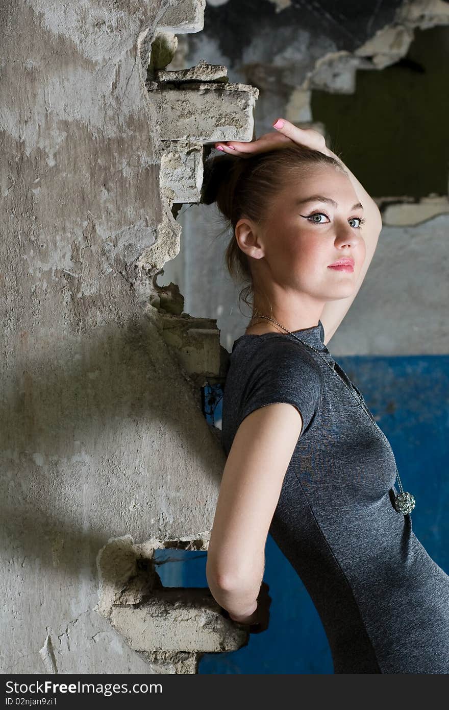 Attractive young lady posing somewhere in industrial ruins. Attractive young lady posing somewhere in industrial ruins