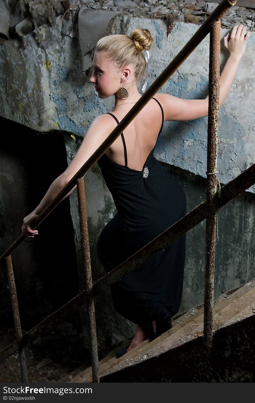 Attractive young lady posing somewhere in industrial ruins. Attractive young lady posing somewhere in industrial ruins