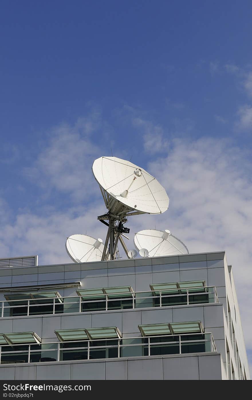 Satellite Dishes on a roof with blue sky background