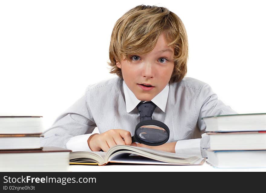 Schoolboy with books and magnifying glass isolated on white