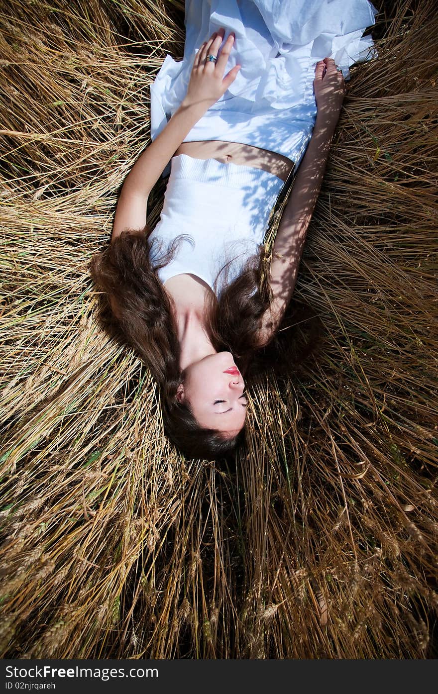 Beautiful young woman having fun on a wheat field. Beautiful young woman having fun on a wheat field