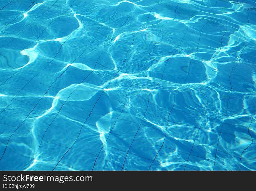 Blue fresh vibrant water in swimming pool. Blue fresh vibrant water in swimming pool