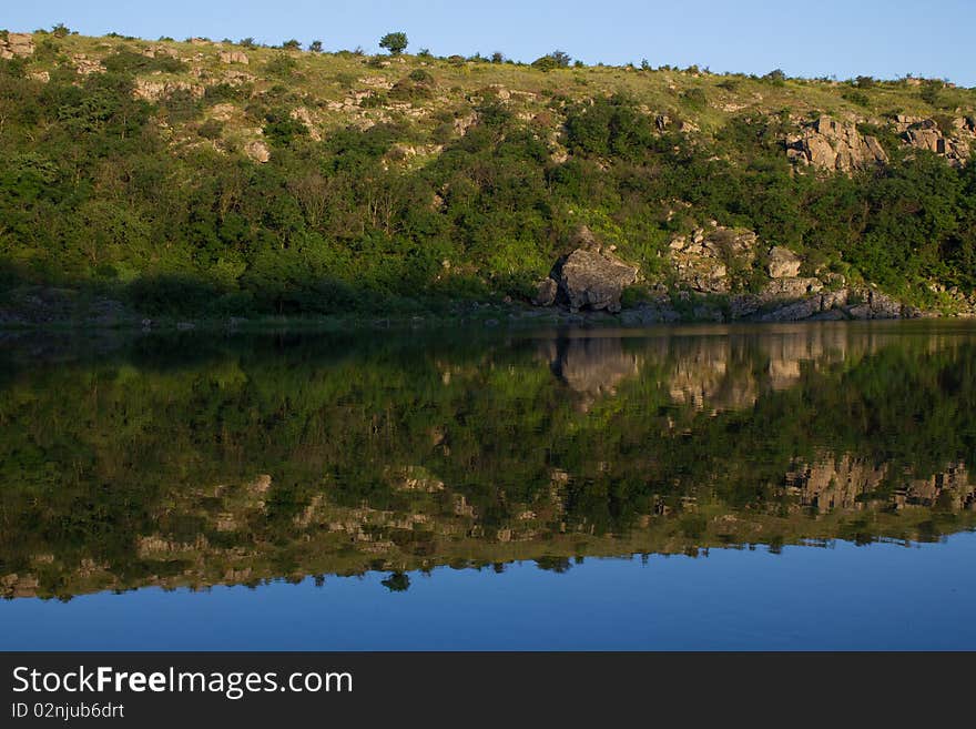 Rocks and stone are reflected in the river