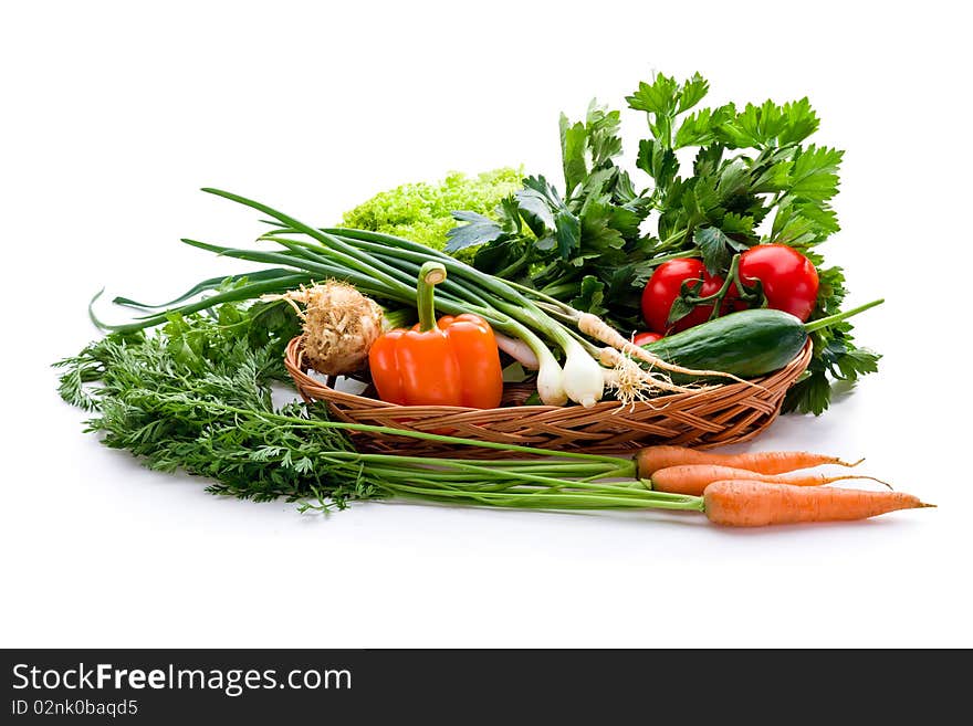 Organic vegetables in basket on white background