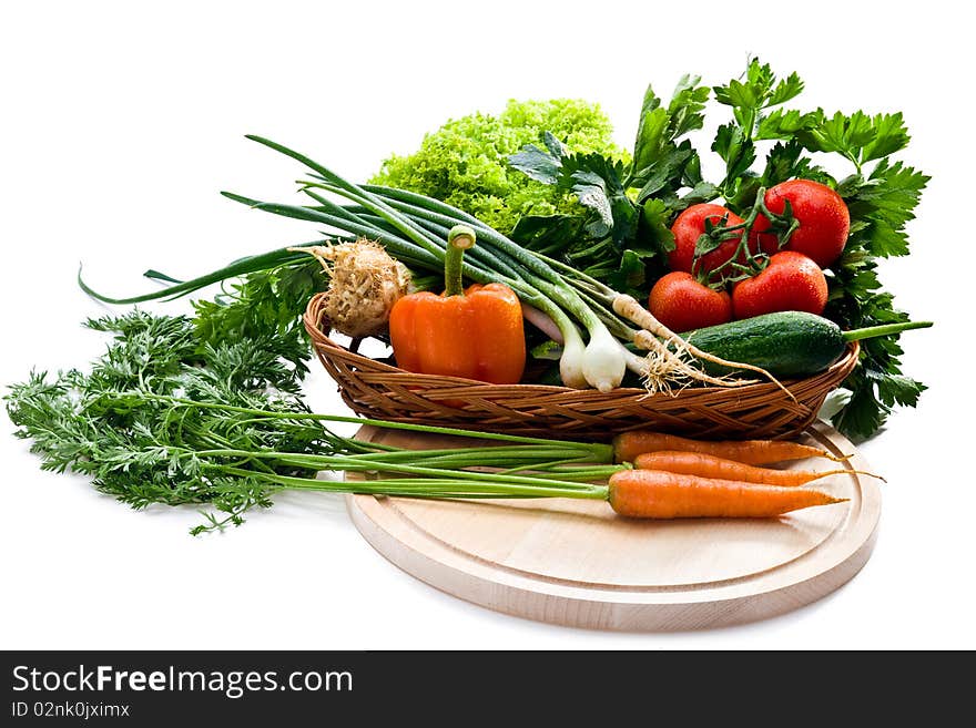 Organic vegetables in basket on white background