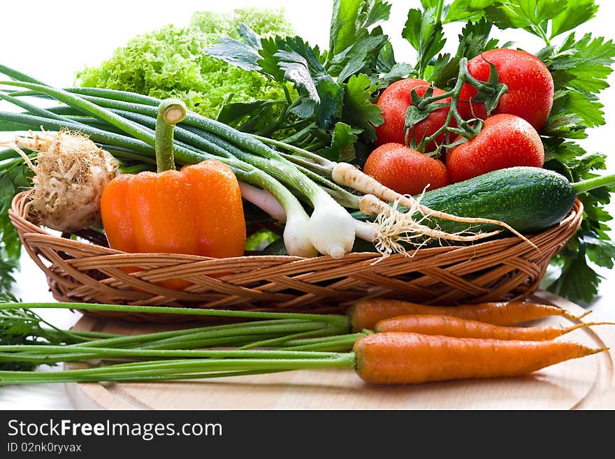 Organic vegetables in basket on white background