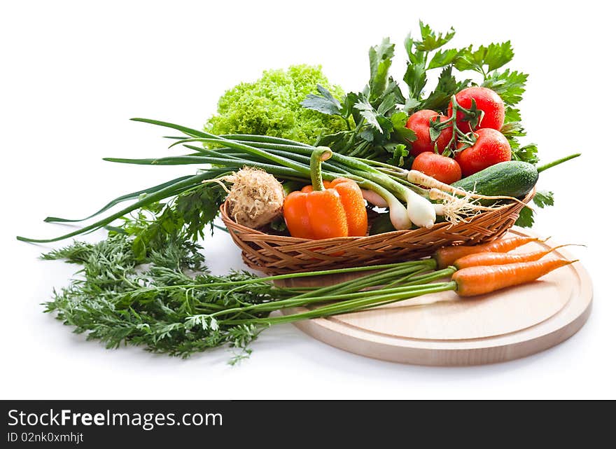 Organic vegetables in basket on white background