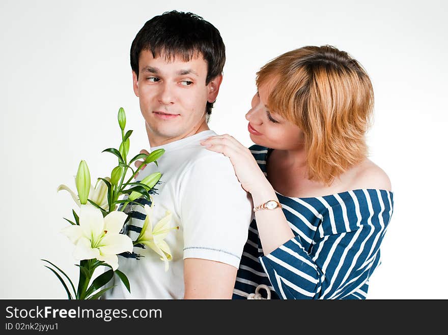 Beautiful young couple with white lilies