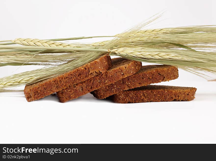 Grain cereals over the baked bread on light background