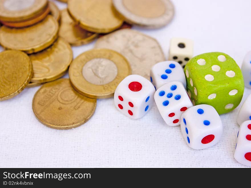 Coins and different dice on white. Coins and different dice on white