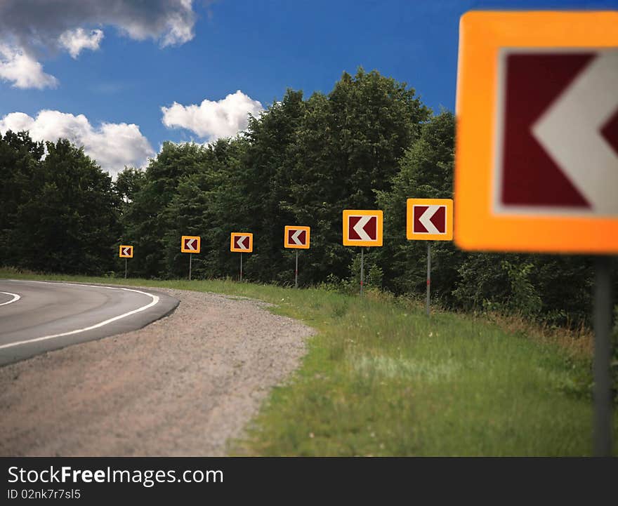 Signs attention to road turn in wood. Signs attention to road turn in wood