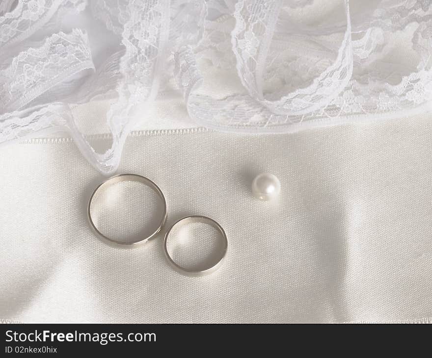 With golden rings, pearl and lace. With golden rings, pearl and lace