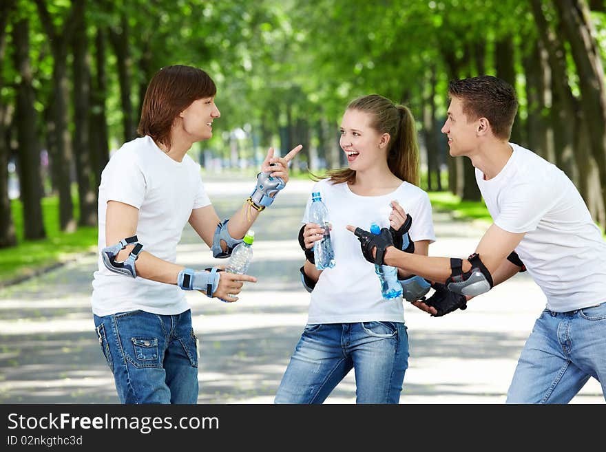 Three young people in the outfit of drinking water. Three young people in the outfit of drinking water