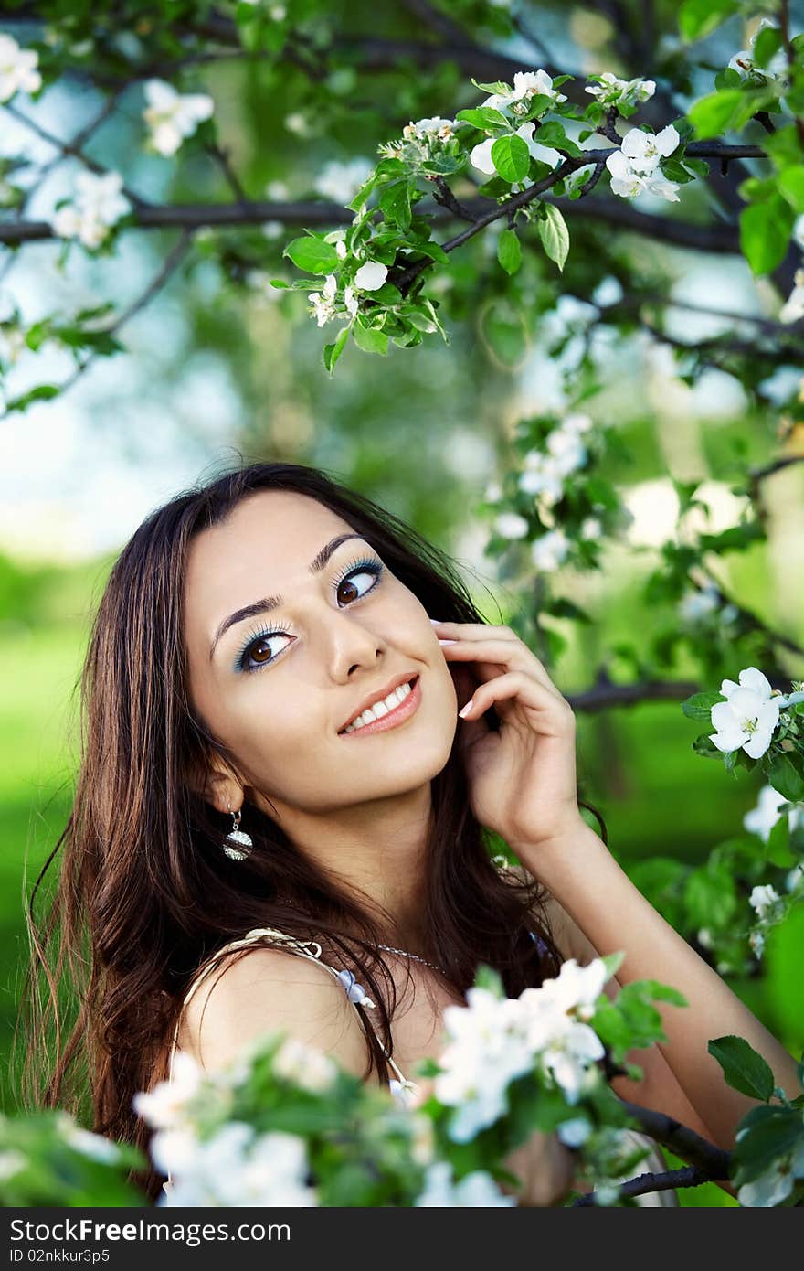 Attractive girl on a background of flowering trees. Attractive girl on a background of flowering trees