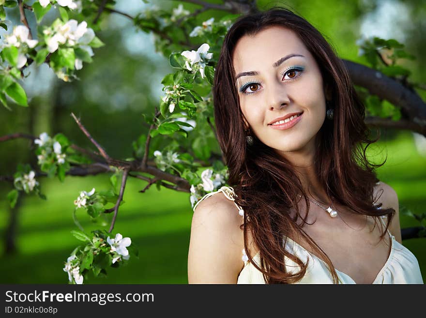 Attractive girl on a background of flowering trees. Attractive girl on a background of flowering trees