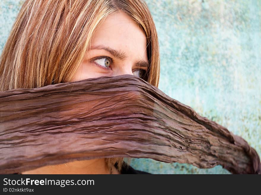 Blonde girl with her mouth hidden by scarf. Blonde girl with her mouth hidden by scarf