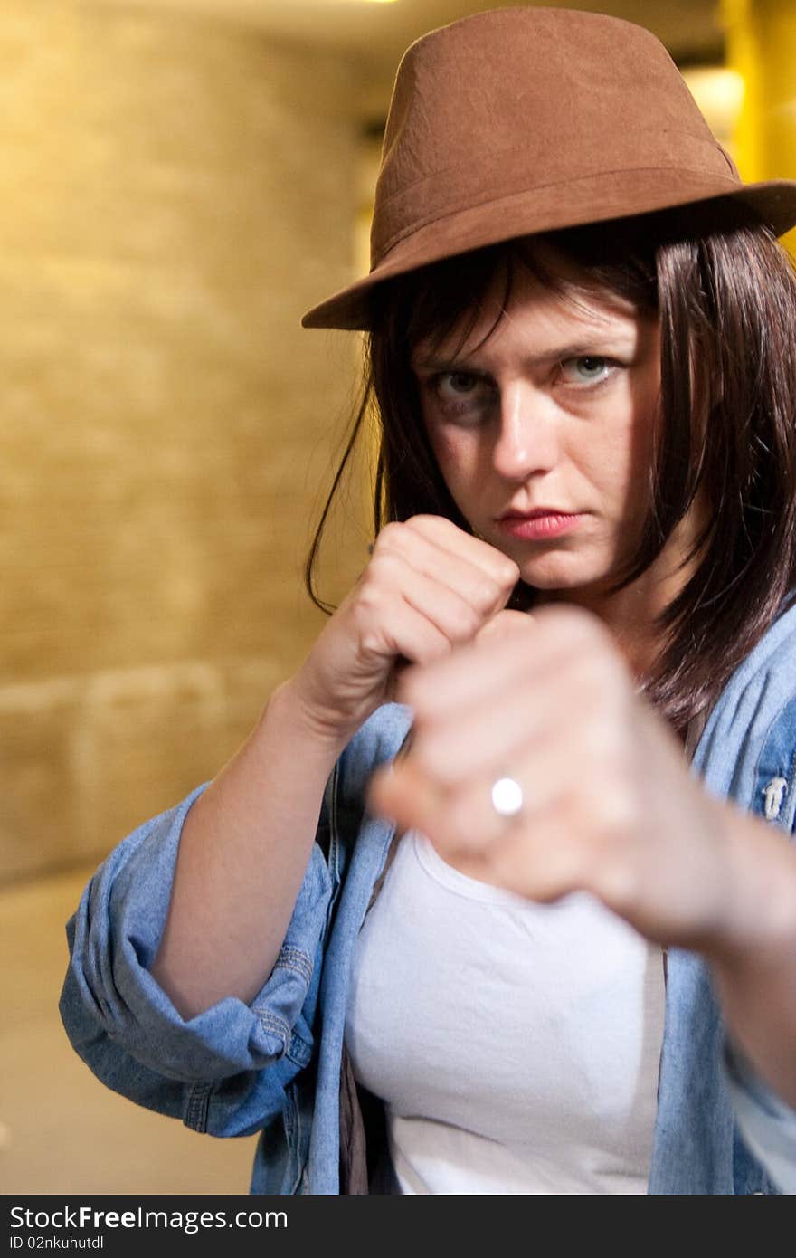 Combative girl in fighting stance fists raised. Combative girl in fighting stance fists raised