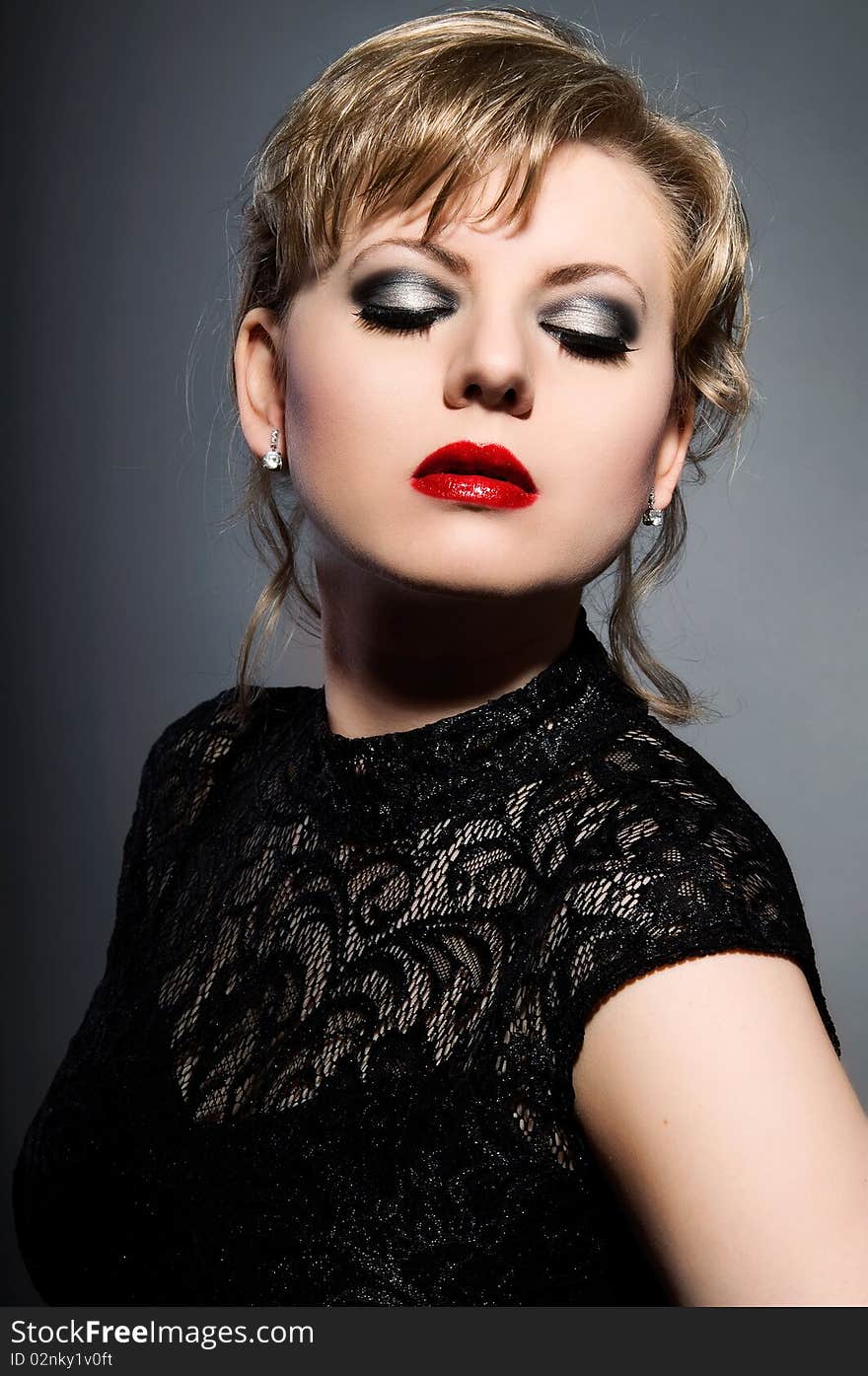 Close-up portrait of young woman with luxury make-up.