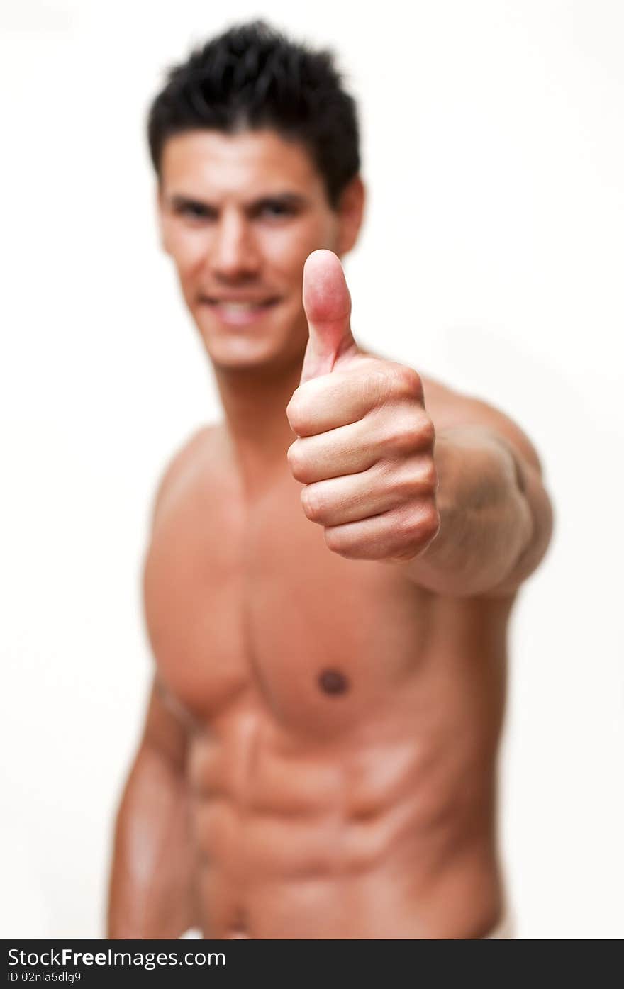 Model photographed in the studio, with focus on the hand with thumb up. Model photographed in the studio, with focus on the hand with thumb up