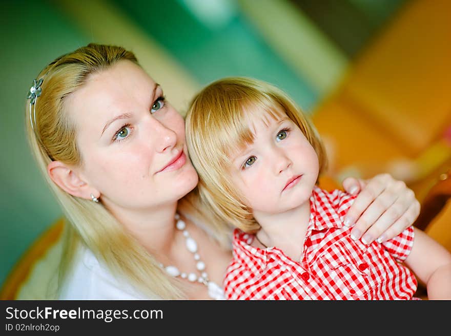 Beautiful mother hug her daughter closeup indoor. Beautiful mother hug her daughter closeup indoor