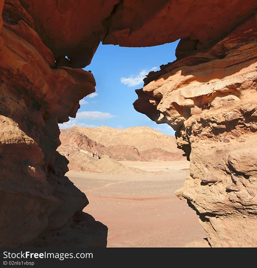 Window in the orange sandstone rock in Negev desert, Israel. Window in the orange sandstone rock in Negev desert, Israel