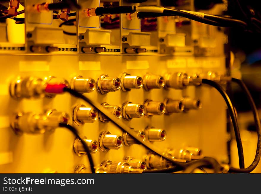 Orange Rack Mounted Servers with cables.;landscape shot