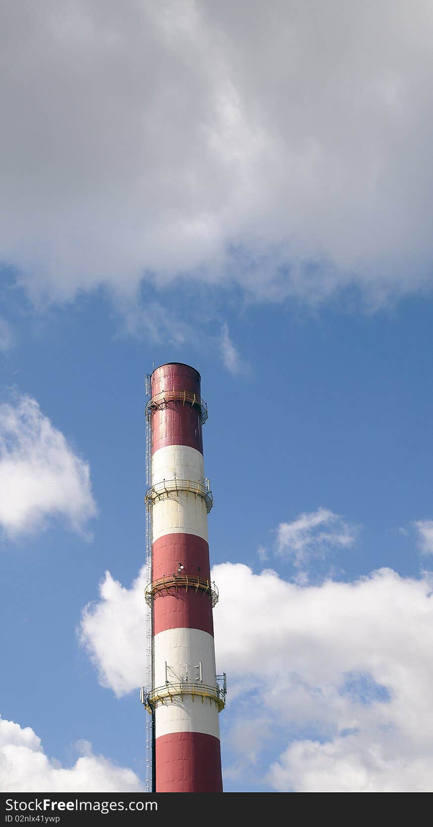 Chimney-stalk on a blue sky. July morning,