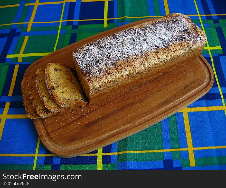 Sliced sponge cake on a wooden board. Sliced sponge cake on a wooden board