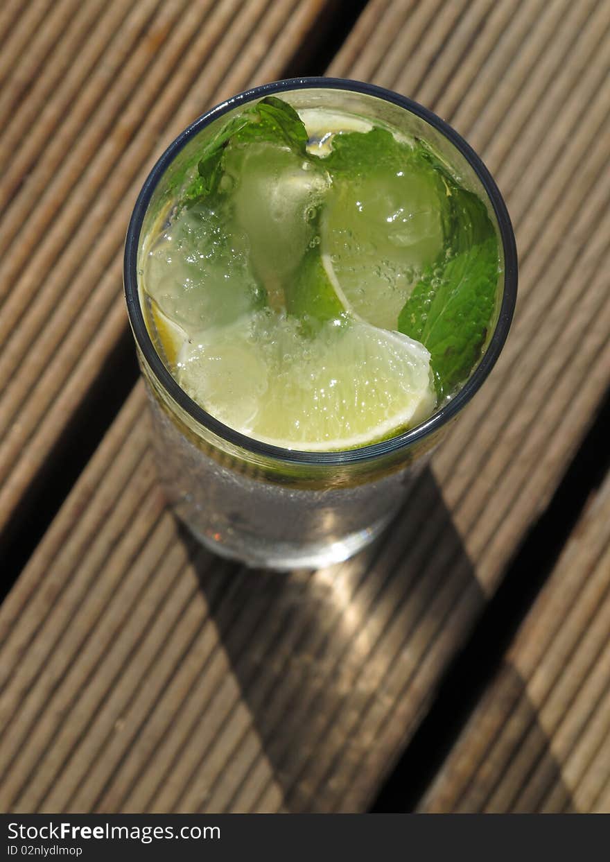 Fresh summer at the beach table cocktail contain ice and mint. Fresh summer at the beach table cocktail contain ice and mint