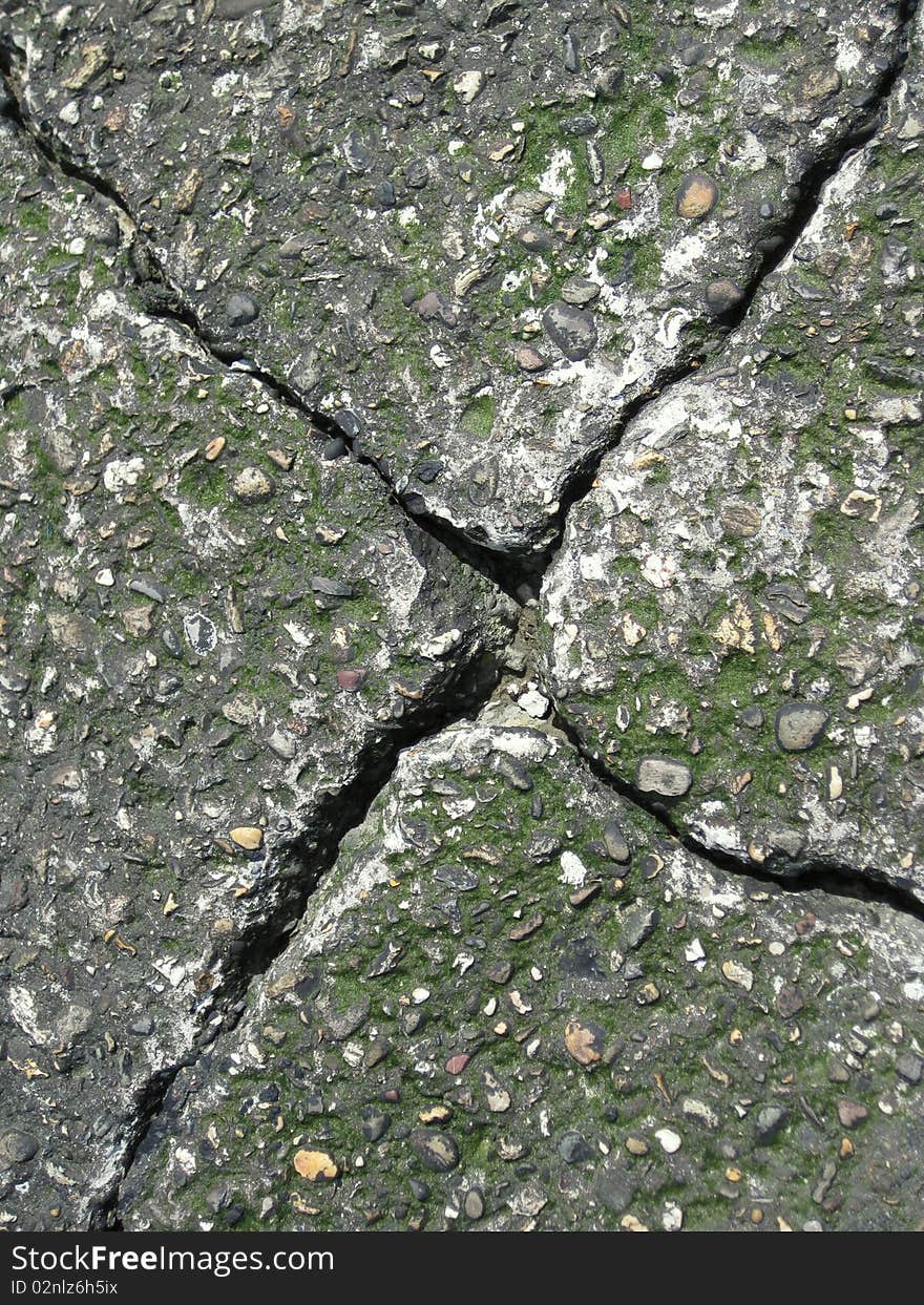 A broken tile with moss