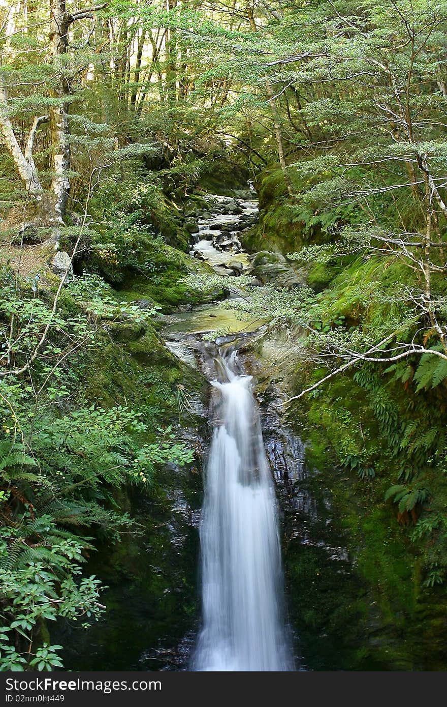 A small stream running over a waterfall, Otago, New Zealand. A small stream running over a waterfall, Otago, New Zealand