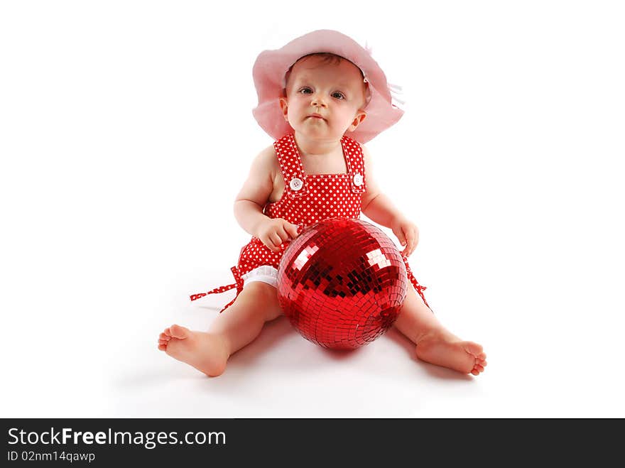 Little baby girl in red dress and hat with red ball