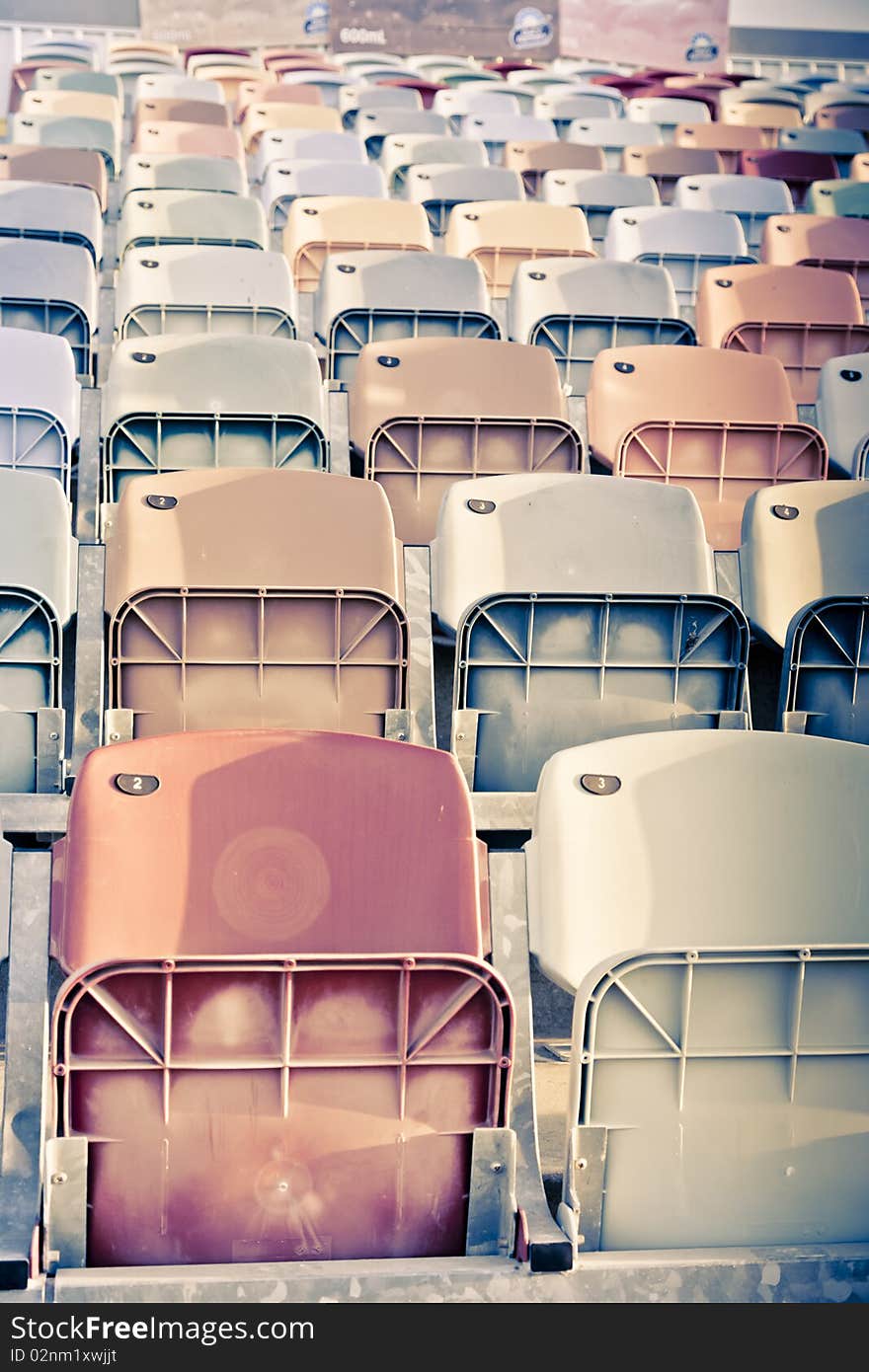 Old faded Stadium Seats on a row. Old faded Stadium Seats on a row