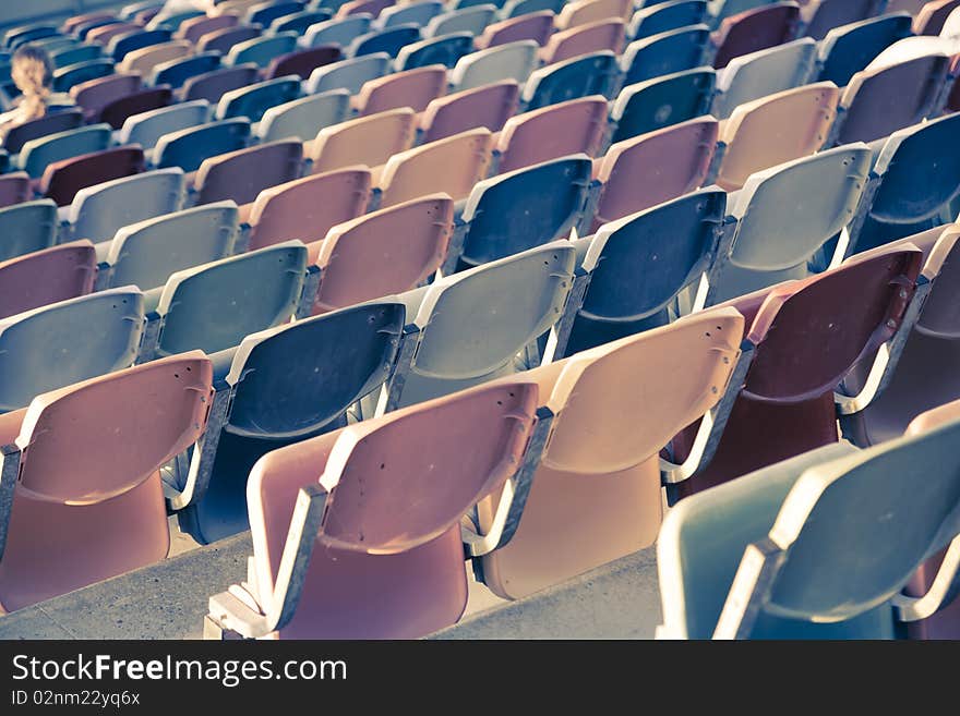 Rows of old faded Stadium Seats. Rows of old faded Stadium Seats