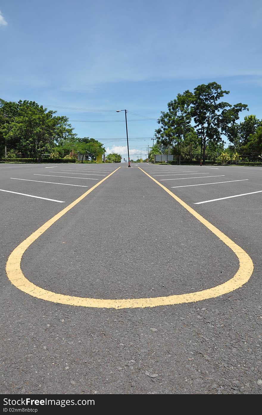 Empty parking lane with blue sky