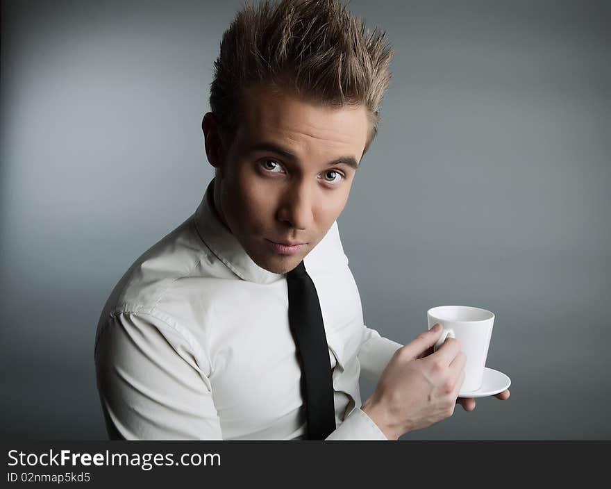 Young attractive macho drinking coffe. photo