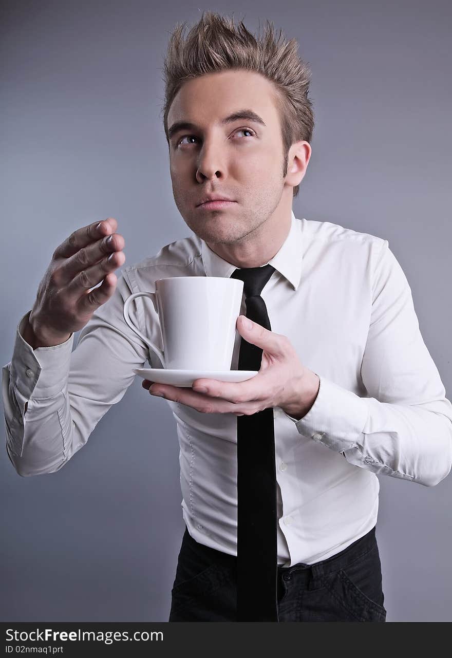 Young attractive macho drinking coffe. photo