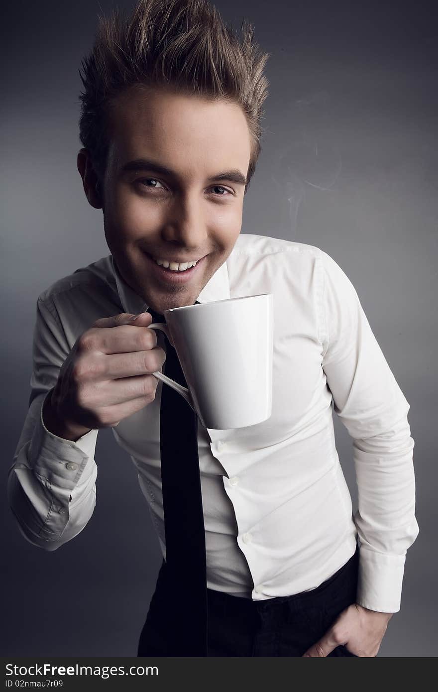 Young attractive macho drinking coffe. photo