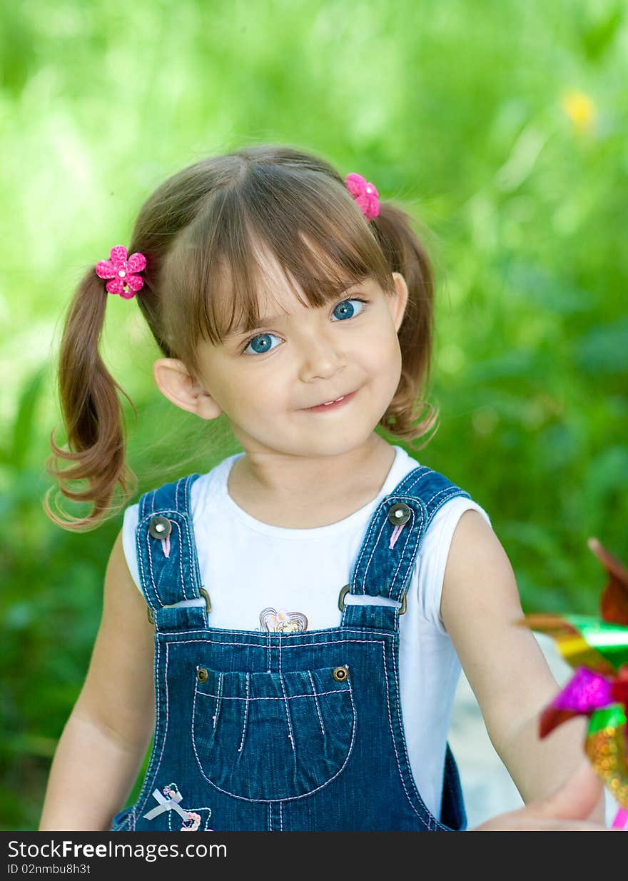 Smiling little girl in jeans with blue eyes outdoor. Smiling little girl in jeans with blue eyes outdoor