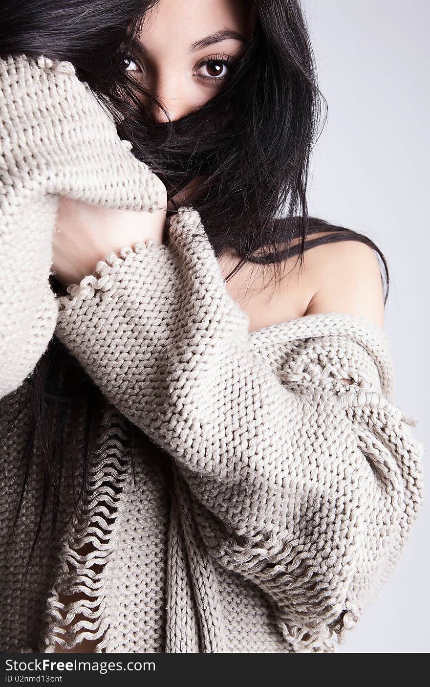 Charming brunette hiding her face by hair. Fashion Photo.