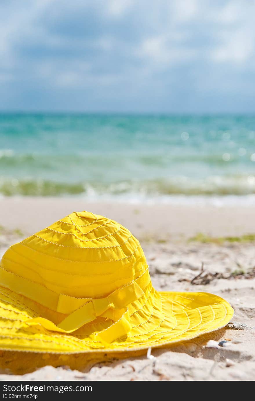 One yellow hat in the beach near sea