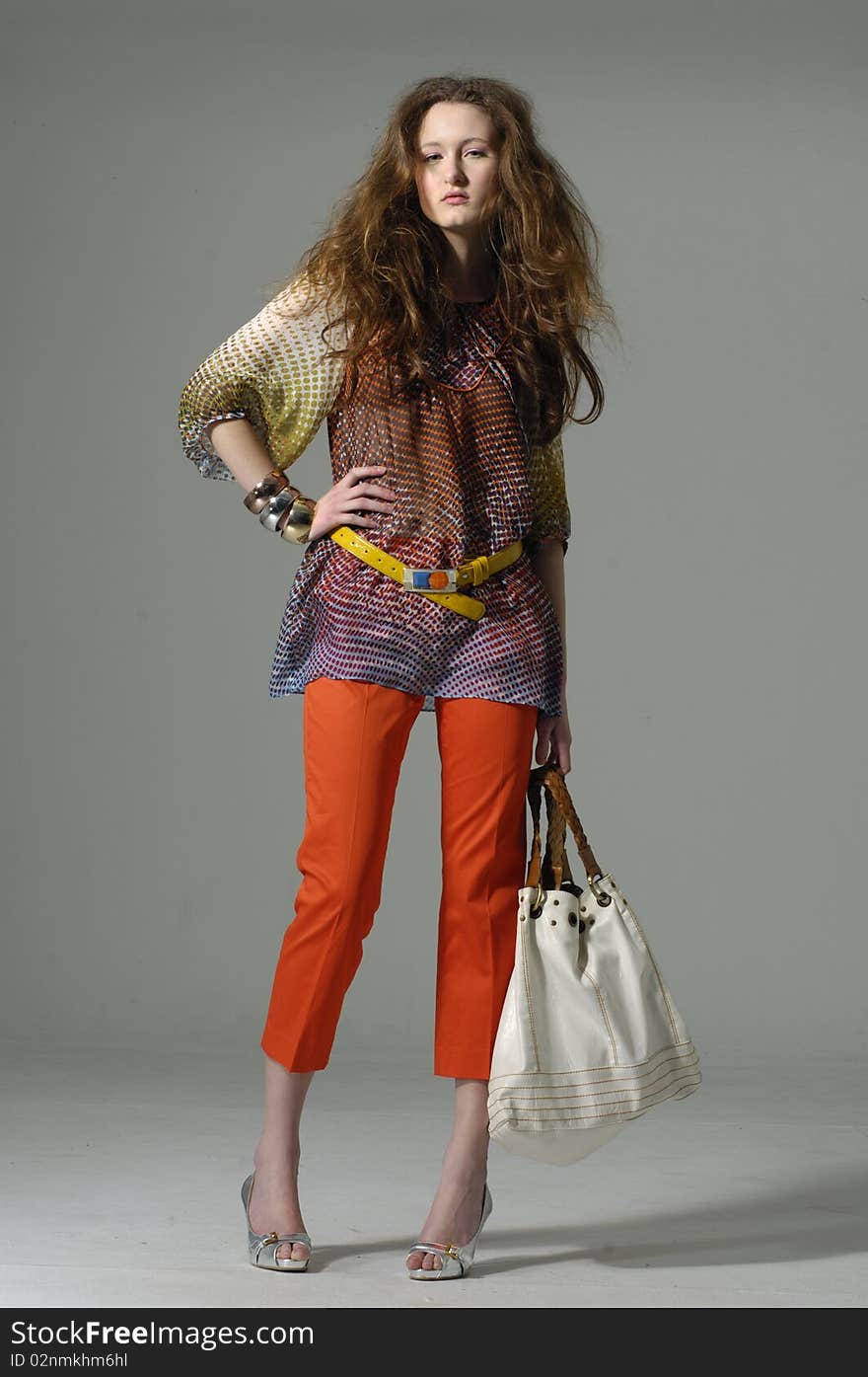 Fashion model with bag posing in the studio