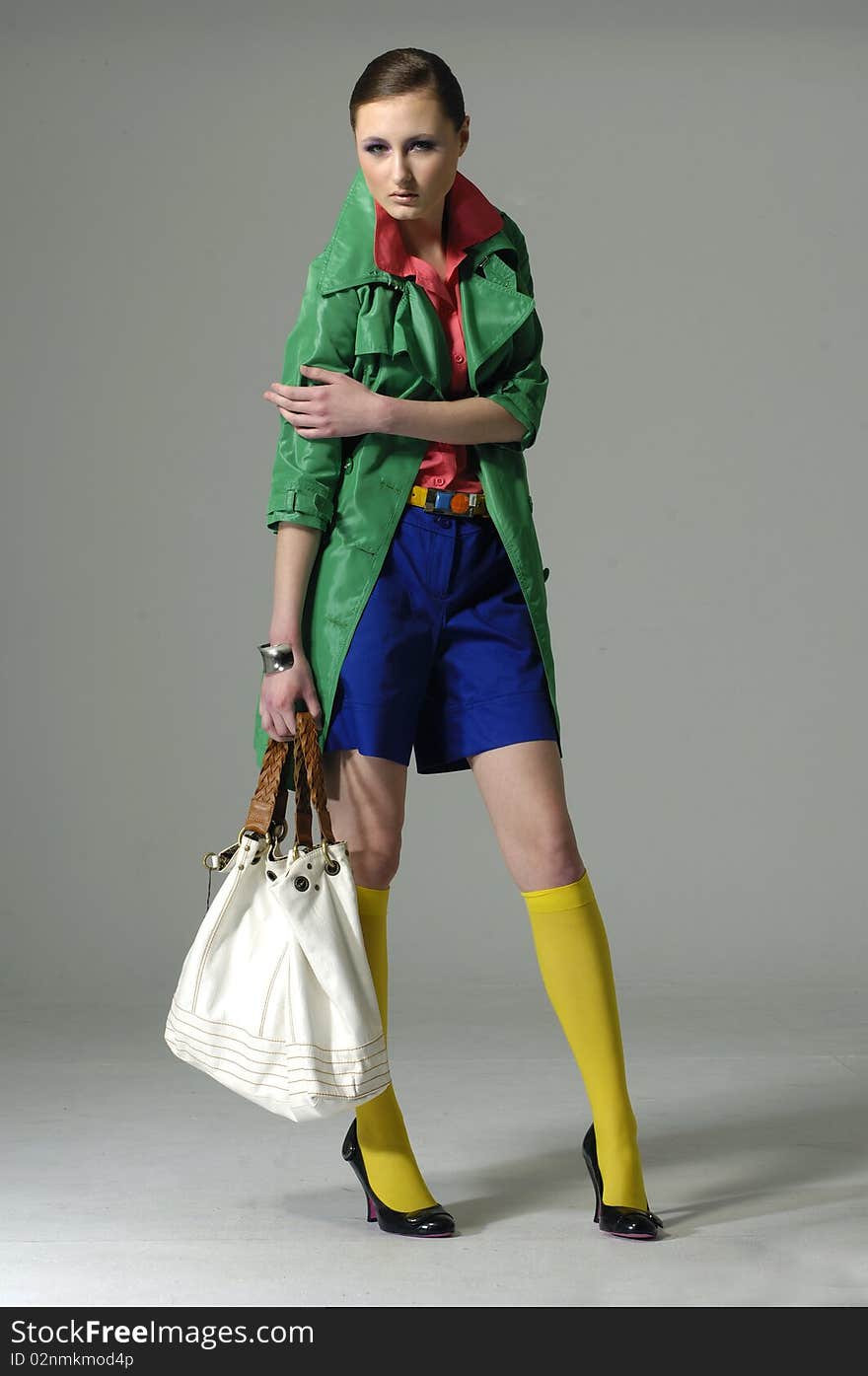 Fashion model with bag posing in the studio