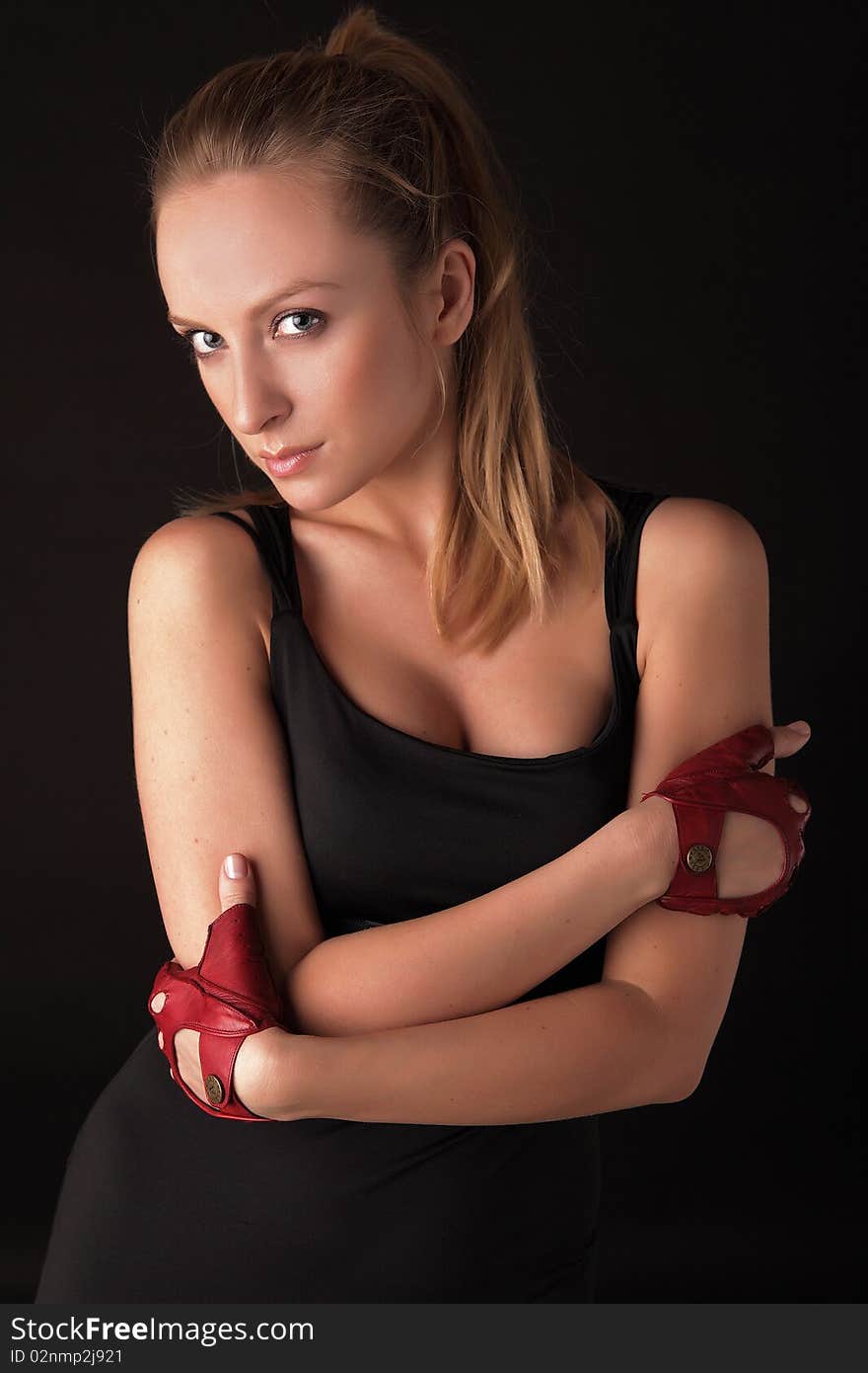 Attractive posing blonde in a red sport gloves. Fashion photo.