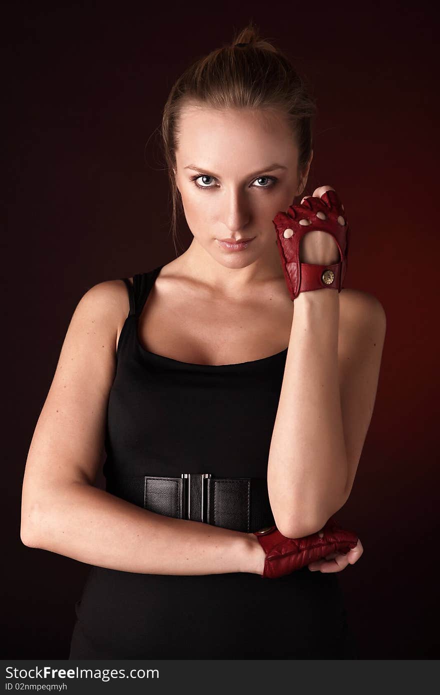 Attractive posing blonde in a red sport gloves