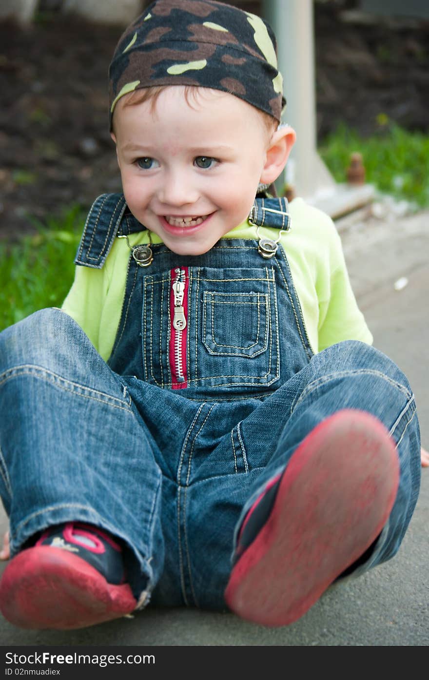 A boy sitting on the ground