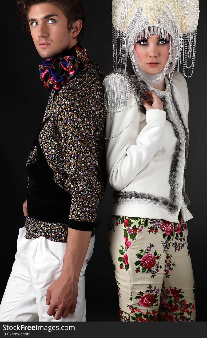 Pair models in exclusive design clothes on manners old-slavic. Photo.